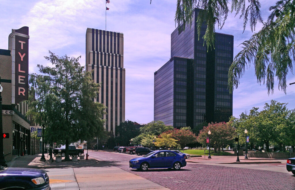 Street view with buildings and a blue car