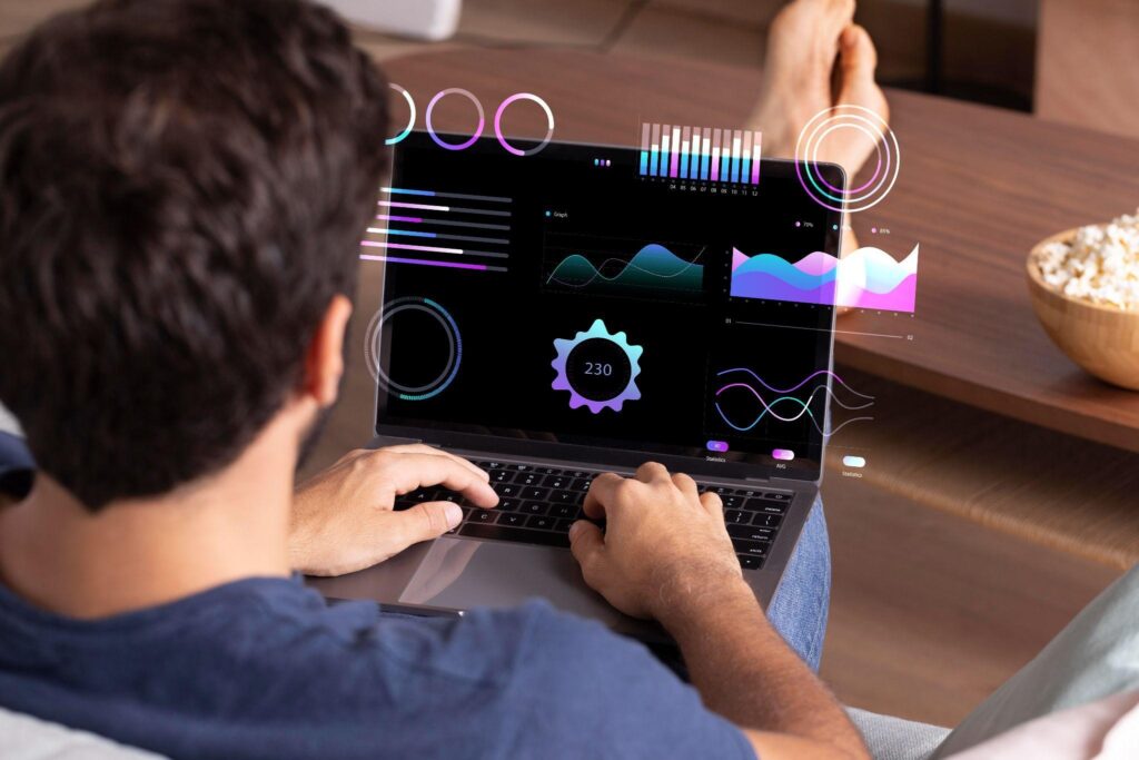 Man analyzing data on laptop at home.