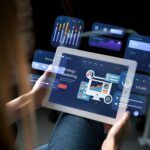 Person holding tablet with digital marketing graphics.