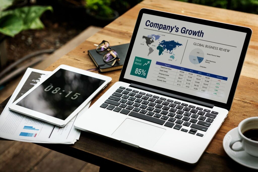 Tablet and laptop showing company's growth report.
