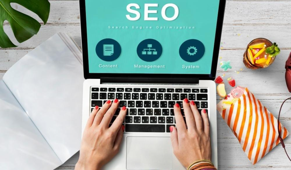 Hands typing on laptop showing SEO concepts.