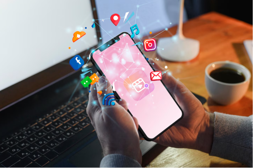 Hands holding smartphone with social media icons.